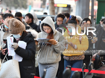 Candidates are preparing to enter the entrance exam for postgraduate students at the No. 15 Middle School exam center in Fuyang, China, on D...