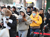 Candidates are preparing to enter the entrance exam for postgraduate students at the No. 15 Middle School exam center in Fuyang, China, on D...