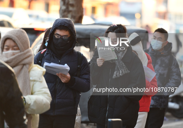 Candidates are preparing to enter the entrance exam for postgraduate students at the No. 15 Middle School exam center in Fuyang, China, on D...