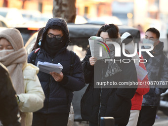 Candidates are preparing to enter the entrance exam for postgraduate students at the No. 15 Middle School exam center in Fuyang, China, on D...