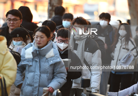 Candidates are preparing to enter the entrance exam for postgraduate students at the No. 15 Middle School exam center in Fuyang, China, on D...