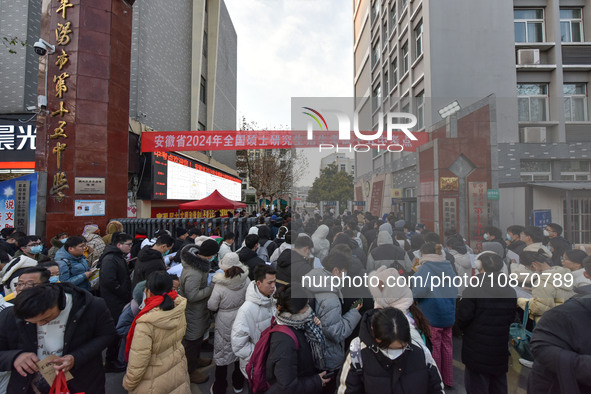 Candidates are preparing to enter the entrance exam for postgraduate students at the No. 15 Middle School exam center in Fuyang, China, on D...