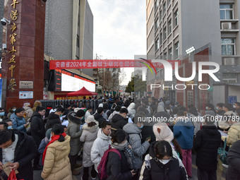 Candidates are preparing to enter the entrance exam for postgraduate students at the No. 15 Middle School exam center in Fuyang, China, on D...