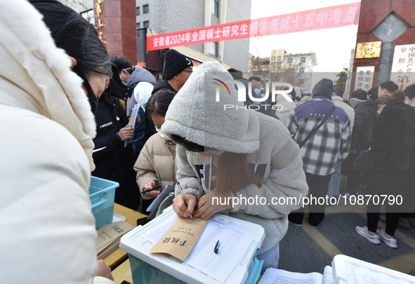 Candidates are preparing to enter the entrance exam for postgraduate students at the No. 15 Middle School exam center in Fuyang, China, on D...