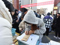 Candidates are preparing to enter the entrance exam for postgraduate students at the No. 15 Middle School exam center in Fuyang, China, on D...