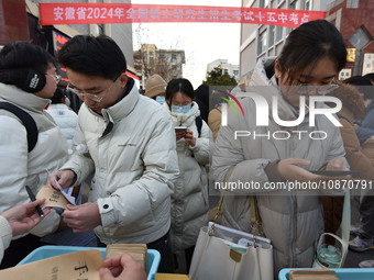 Candidates are preparing to enter the entrance exam for postgraduate students at the No. 15 Middle School exam center in Fuyang, China, on D...