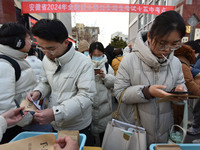 Candidates are preparing to enter the entrance exam for postgraduate students at the No. 15 Middle School exam center in Fuyang, China, on D...