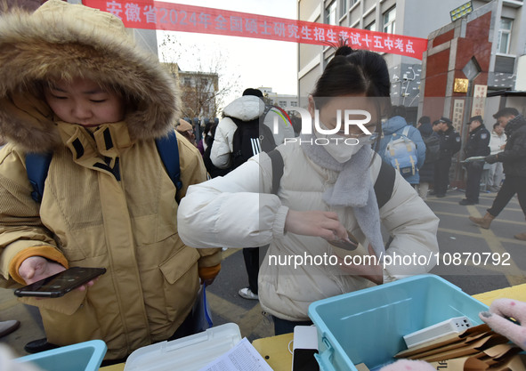 Candidates are preparing to enter the entrance exam for postgraduate students at the No. 15 Middle School exam center in Fuyang, China, on D...