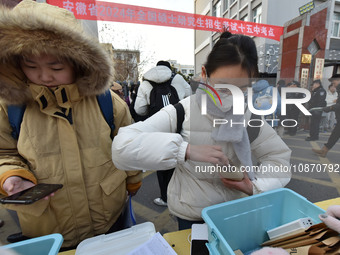 Candidates are preparing to enter the entrance exam for postgraduate students at the No. 15 Middle School exam center in Fuyang, China, on D...