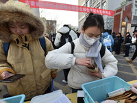 Candidates are preparing to enter the entrance exam for postgraduate students at the No. 15 Middle School exam center in Fuyang, China, on D...