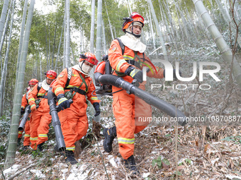 Forest firefighters are conducting a fire prevention and emergency response drill in Dayao village, Moganshan town, Huzhou city, Zhejiang pr...