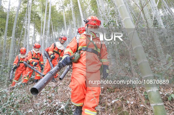 Forest firefighters are conducting a fire prevention and emergency response drill in Dayao village, Moganshan town, Huzhou city, Zhejiang pr...