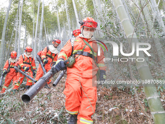 Forest firefighters are conducting a fire prevention and emergency response drill in Dayao village, Moganshan town, Huzhou city, Zhejiang pr...