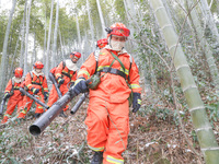 Forest firefighters are conducting a fire prevention and emergency response drill in Dayao village, Moganshan town, Huzhou city, Zhejiang pr...