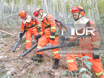 Forest firefighters are conducting a fire prevention and emergency response drill in Dayao village, Moganshan town, Huzhou city, Zhejiang pr...