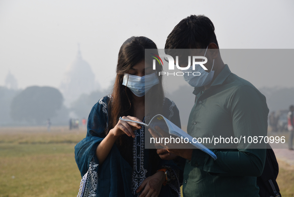 People are wearing protective masks in Kolkata, India, on December 23, 2023. 