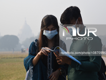 People are wearing protective masks in Kolkata, India, on December 23, 2023. (