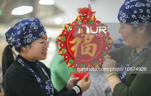 Students are learning to knit Chinese knots at a vocational training school on Dexi Street in Zouping, China, on December 25, 2023. 