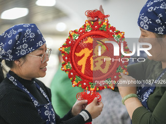 Students are learning to knit Chinese knots at a vocational training school on Dexi Street in Zouping, China, on December 25, 2023. (