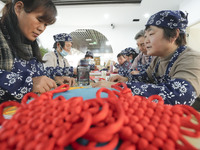 Students are learning to knit Chinese knots at a vocational training school on Dexi Street in Zouping, China, on December 25, 2023. (