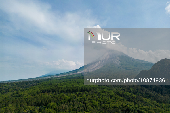 Mount Merapi volcano is spewing smoke as seen from Turgo village in the Sleman district of Yogyakarta, Indonesia, on December 25, 2023. Auth...