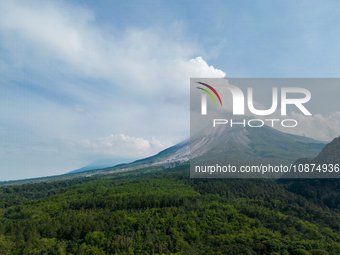 Mount Merapi volcano is spewing smoke as seen from Turgo village in the Sleman district of Yogyakarta, Indonesia, on December 25, 2023. Auth...