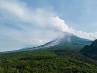 Mount Merapi volcano is spewing smoke as seen from Turgo village in the Sleman district of Yogyakarta, Indonesia, on December 25, 2023. Auth...