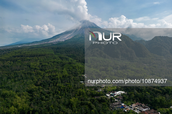 Mount Merapi volcano is spewing smoke as seen from Turgo village in the Sleman district of Yogyakarta, Indonesia, on December 25, 2023. Auth...