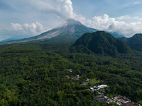 Mount Merapi volcano is spewing smoke as seen from Turgo village in the Sleman district of Yogyakarta, Indonesia, on December 25, 2023. Auth...