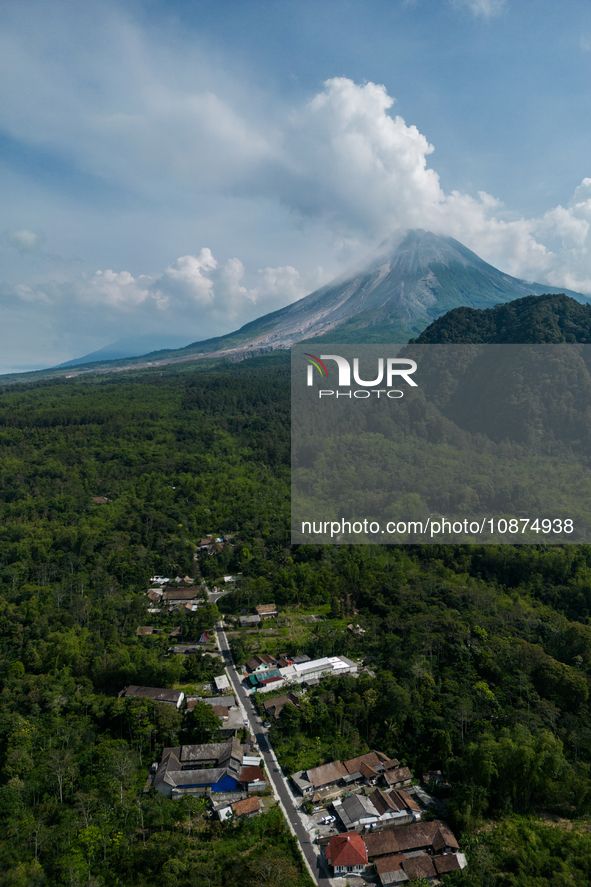 Mount Merapi volcano is spewing smoke as seen from Turgo village in the Sleman district of Yogyakarta, Indonesia, on December 25, 2023. Auth...