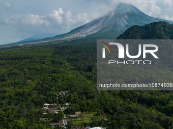 Mount Merapi volcano is spewing smoke as seen from Turgo village in the Sleman district of Yogyakarta, Indonesia, on December 25, 2023. Auth...