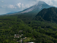 Mount Merapi volcano is spewing smoke as seen from Turgo village in the Sleman district of Yogyakarta, Indonesia, on December 25, 2023. Auth...