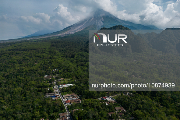 Mount Merapi volcano is spewing smoke as seen from Turgo village in the Sleman district of Yogyakarta, Indonesia, on December 25, 2023. Auth...