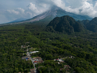 Mount Merapi volcano is spewing smoke as seen from Turgo village in the Sleman district of Yogyakarta, Indonesia, on December 25, 2023. Auth...