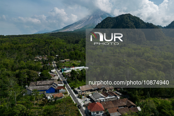 Mount Merapi volcano is spewing smoke as seen from Turgo village in the Sleman district of Yogyakarta, Indonesia, on December 25, 2023. Auth...