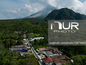 Mount Merapi volcano is spewing smoke as seen from Turgo village in the Sleman district of Yogyakarta, Indonesia, on December 25, 2023. Auth...