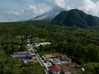 Mount Merapi volcano is spewing smoke as seen from Turgo village in the Sleman district of Yogyakarta, Indonesia, on December 25, 2023. Auth...