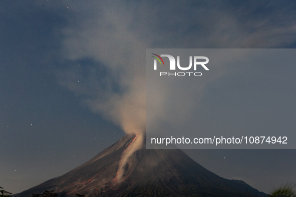 Mount Merapi volcano is spewing lava and smoke as seen from Tunggularum village in the Sleman district of Yogyakarta, Indonesia, on December...