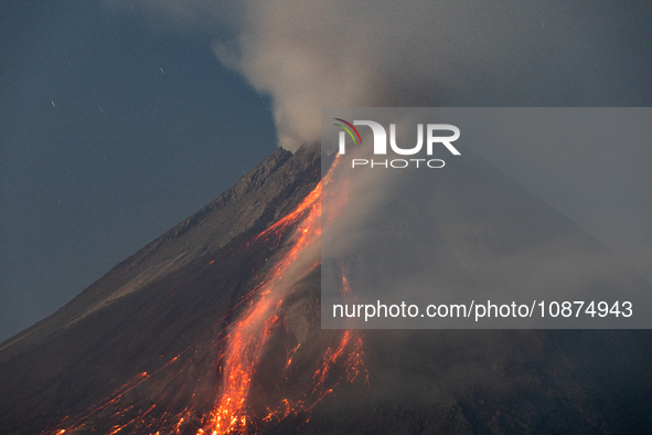 Mount Merapi volcano is spewing lava and smoke as seen from Tunggularum village in the Sleman district of Yogyakarta, Indonesia, on December...