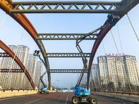 Construction workers are polishing, painting, and maintaining the Zhenxing Bridge in Donghai County, Lianyungang City, Jiangsu Province, Chi...