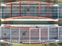 Construction workers are polishing, painting, and maintaining the Zhenxing Bridge in Donghai County, Lianyungang City, Jiangsu Province, Chi...