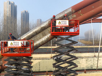 Construction workers are polishing, painting, and maintaining the Zhenxing Bridge in Donghai County, Lianyungang City, Jiangsu Province, Chi...