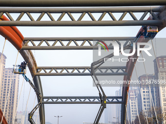 Construction workers are polishing, painting, and maintaining the Zhenxing Bridge in Donghai County, Lianyungang City, Jiangsu Province, Chi...