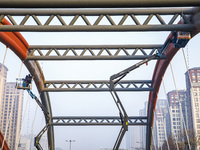 Construction workers are polishing, painting, and maintaining the Zhenxing Bridge in Donghai County, Lianyungang City, Jiangsu Province, Chi...