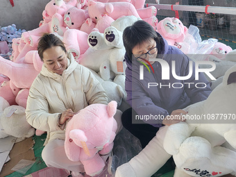 Workers are processing plush toys for export at a toy factory in Lianyungang City, East China's Jiangsu Province, on December 28, 2023. (