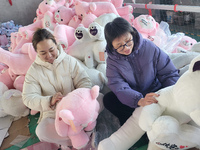 Workers are processing plush toys for export at a toy factory in Lianyungang City, East China's Jiangsu Province, on December 28, 2023. (