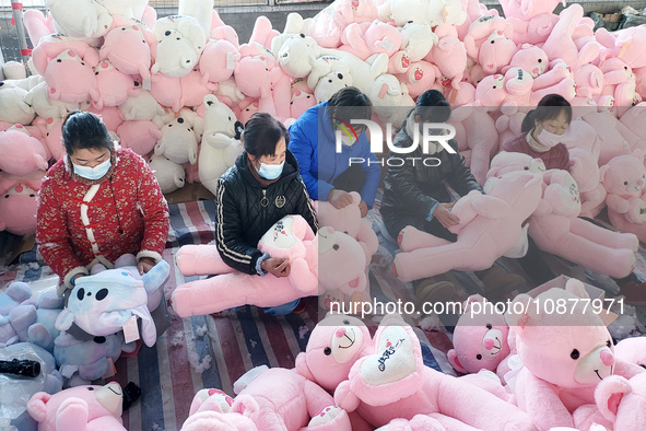 Workers are processing plush toys for export at a toy factory in Lianyungang City, East China's Jiangsu Province, on December 28, 2023. 