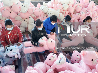 Workers are processing plush toys for export at a toy factory in Lianyungang City, East China's Jiangsu Province, on December 28, 2023. (