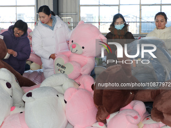 Workers are processing plush toys for export at a toy factory in Lianyungang City, East China's Jiangsu Province, on December 28, 2023. (