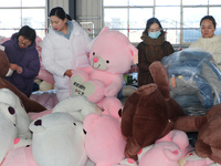 Workers are processing plush toys for export at a toy factory in Lianyungang City, East China's Jiangsu Province, on December 28, 2023. (